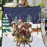 Navy and white Christmas quilt with Santa riding a reindeer and green pine trees