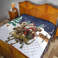Christmas quilt on bed in navy and white with Santa, reindeer, and green pine trees