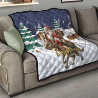 Navy and white Christmas quilt on sofa showing Santa, reindeer, and pine tree graphics