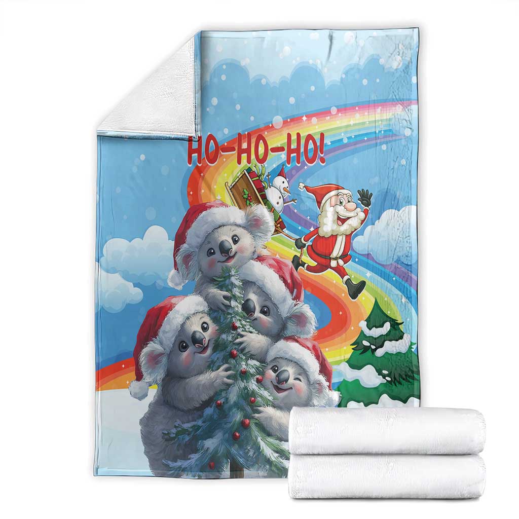 Blue Christmas blanket folded with white towels; koalas and Santa 'HO-HO-HO' design