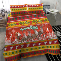 Christmas bedding set on bed: red Santa and reindeer print with green yellow stripe accents