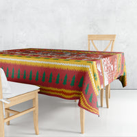 Christmas tablecloth draped over table edge, red green yellow zigzag pattern