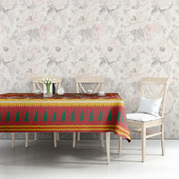 Christmas tablecloth on dining table with red green yellow pine and snowflake motif