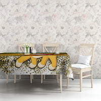 Yellow and black Christmas tablecloth with lion-face pattern and festive border