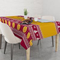 Yellow and maroon holiday tablecloth with lemon slices, zigzag bands, and snowflake icons