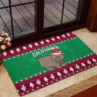 Green Christmas rubber doormat with CALIFORNIA and grizzly in Santa hat at doorway step