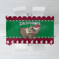 Christmas tablecloth with green-and-maroon border, grizzly bear in Santa hat, California text