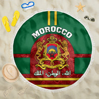 Round Morocco beach blanket, green with tassel fringe and coat of arms crest