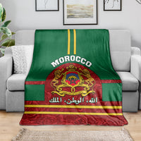 Morocco coat of arms blanket draped on sofa, green and red stripes with crest and lettering