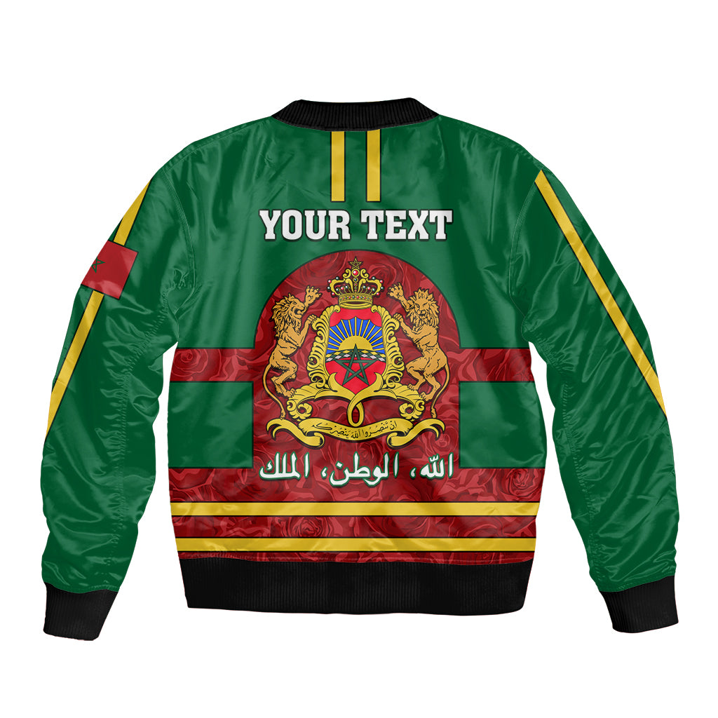 Green bomber jacket with front zipper, Morocco crest graphic, yellow striped trim, sleeve flag patch