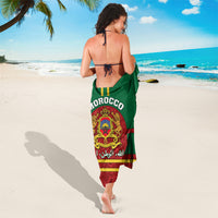 Morocco sarong with green top and red hem, crest emblem and rose-like pattern