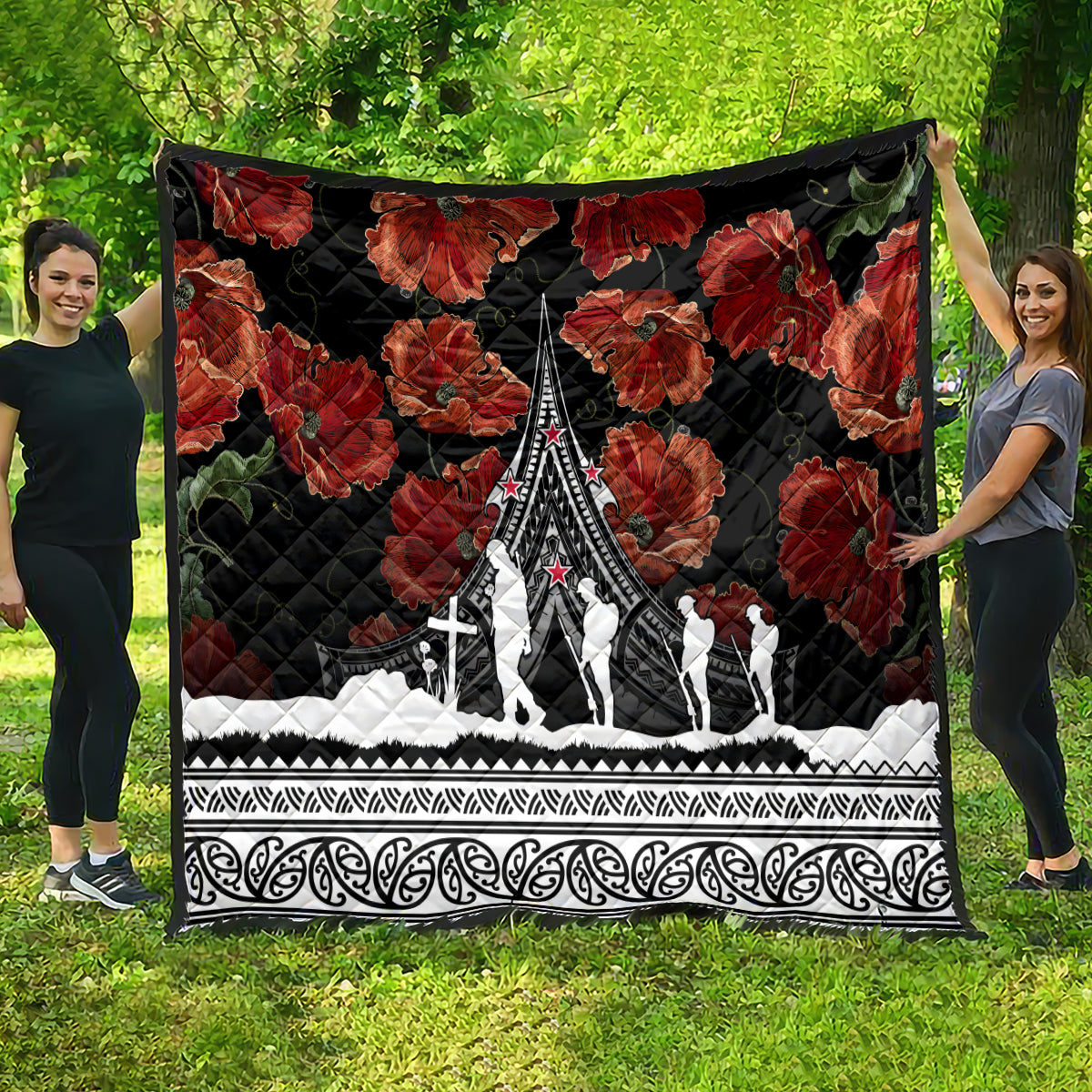 Black poppy quilt with red floral print and white Polynesian border, monument scene in the center