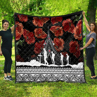 Black poppy quilt with red floral print and white Polynesian border, monument scene in the center