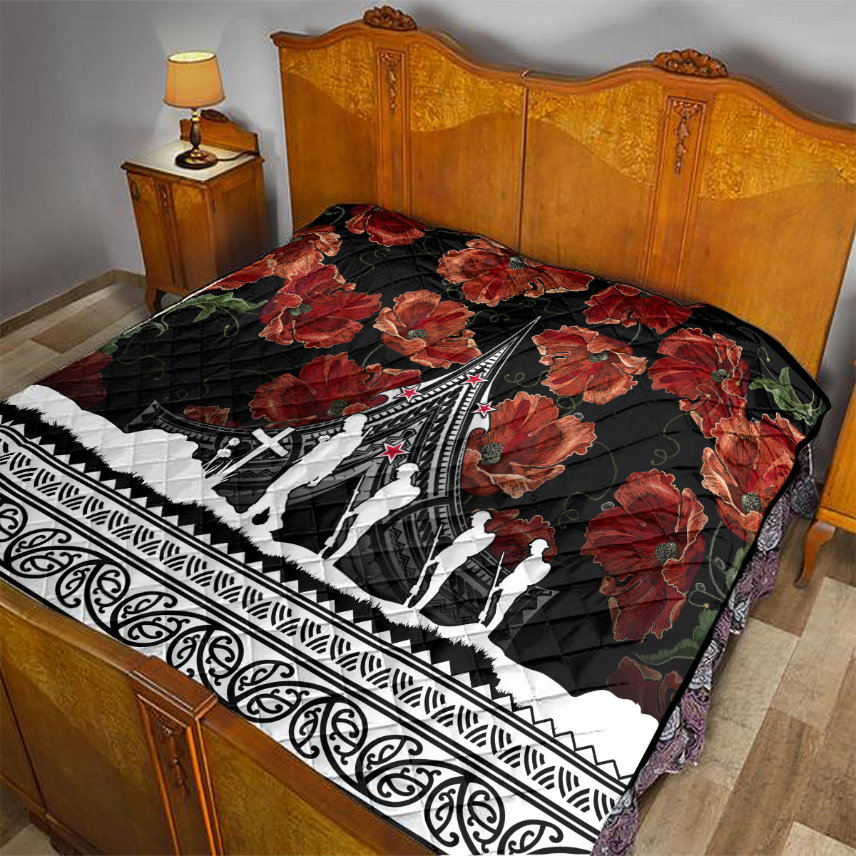 Black and red poppy quilt laid on a bed, with white Polynesian border and central monument artwork