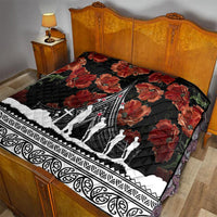 Black and red poppy quilt laid on a bed, with white Polynesian border and central monument artwork