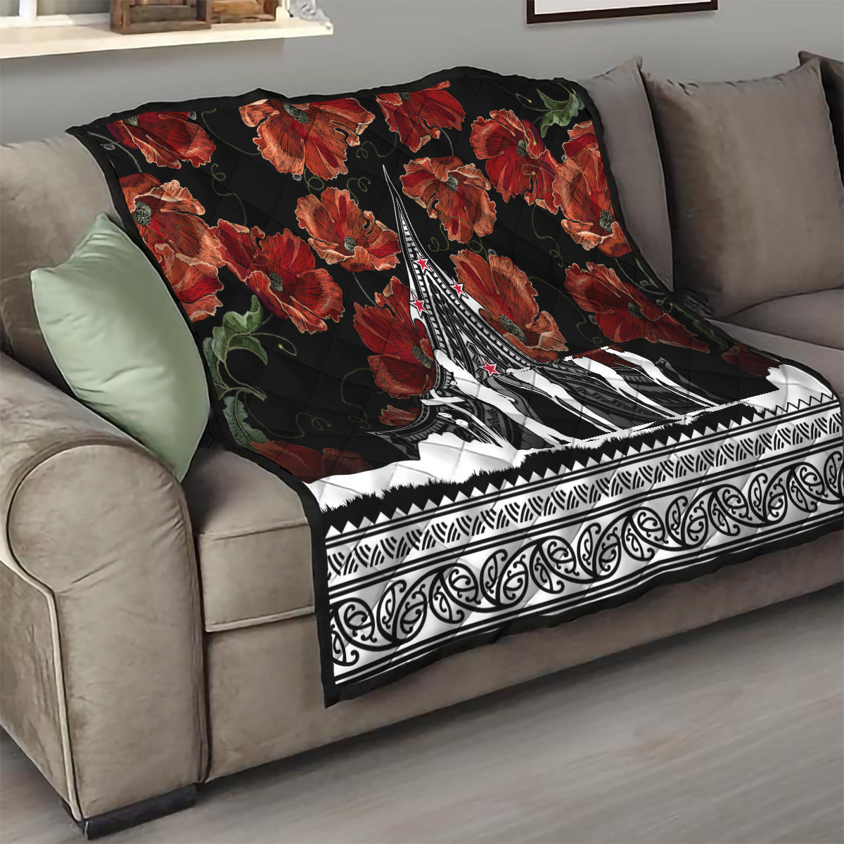 Black sofa throw quilt with red poppies and white Polynesian-style trim, centered monument artwork