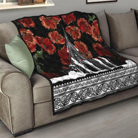 Black sofa throw quilt with red poppies and white Polynesian-style trim, centered monument artwork