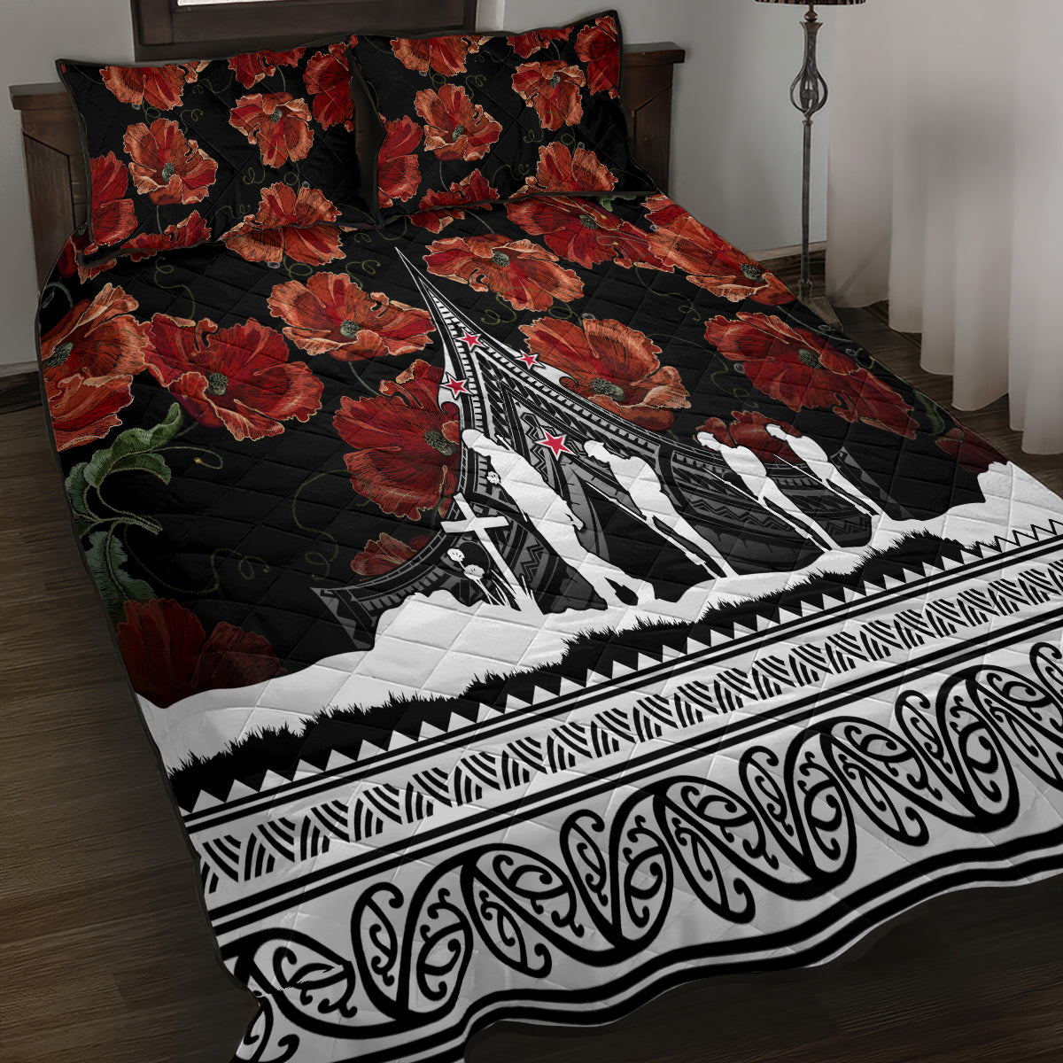 Black quilt bedspread with red poppy florals, Polynesian pattern edge, white aircraft silhouettes.