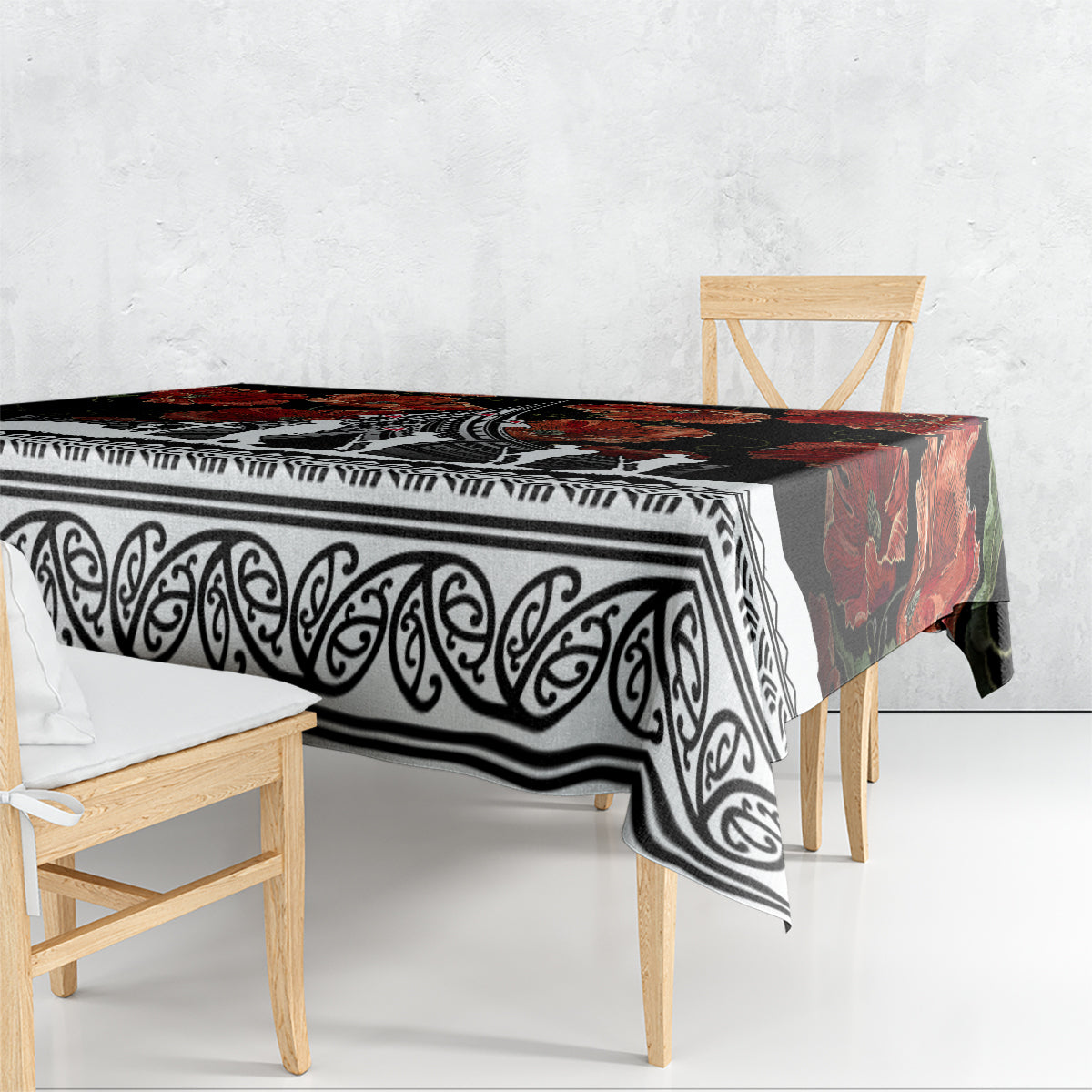 Black tablecloth draped on table with white scroll pattern and red floral sections