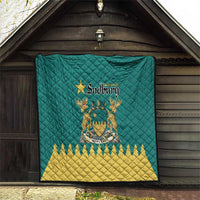 Green quilt displayed indoors with Greater Sudbury crest and yellow zigzag border