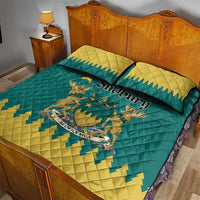 Teal and yellow quilt bed set with emblem artwork and two matching pillows
