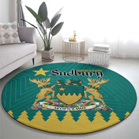 Green round carpet featuring the Sudbury emblem and gold decorative border