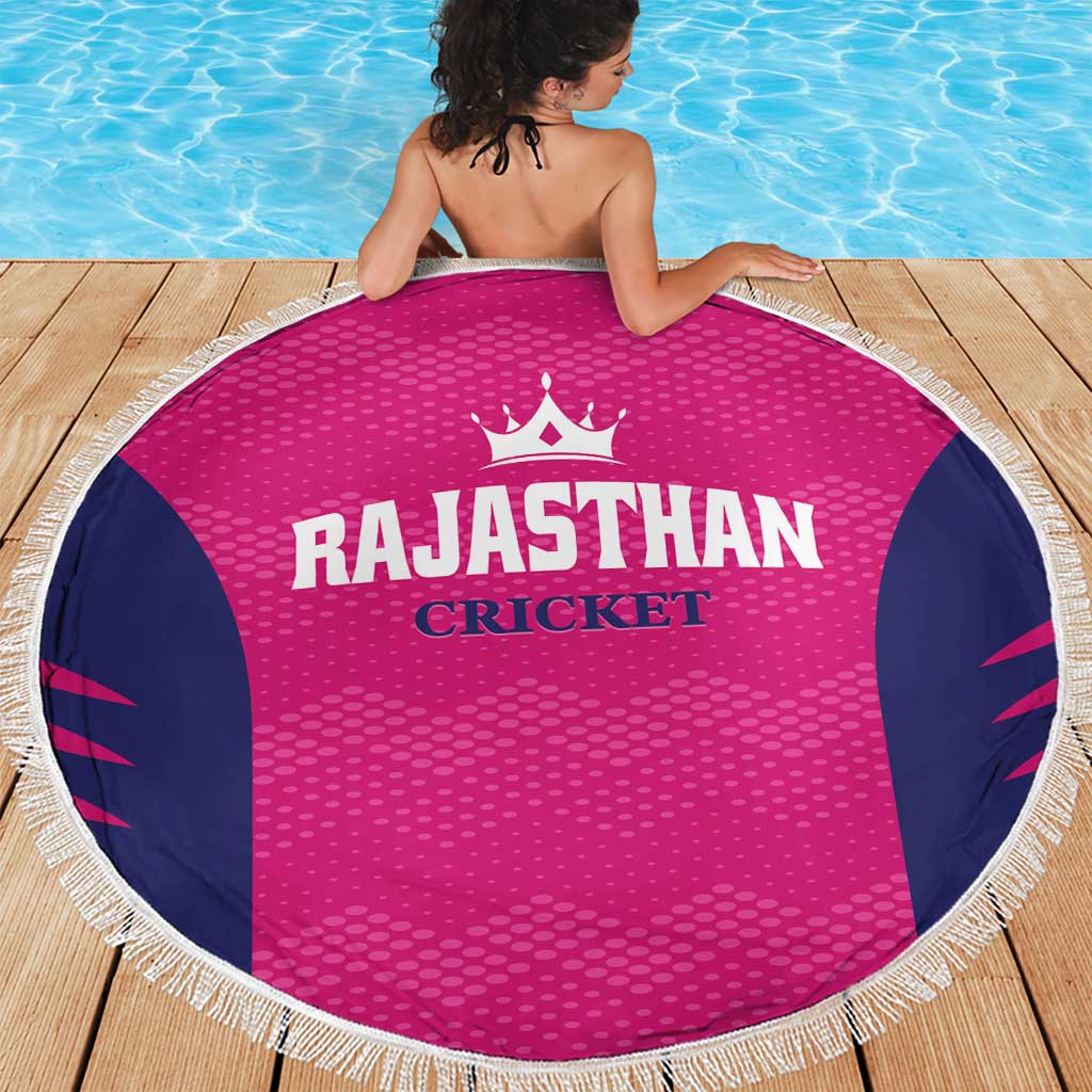 Round pink beach blanket with navy side panels, white fringe border, RAJASTHAN CRICKET print