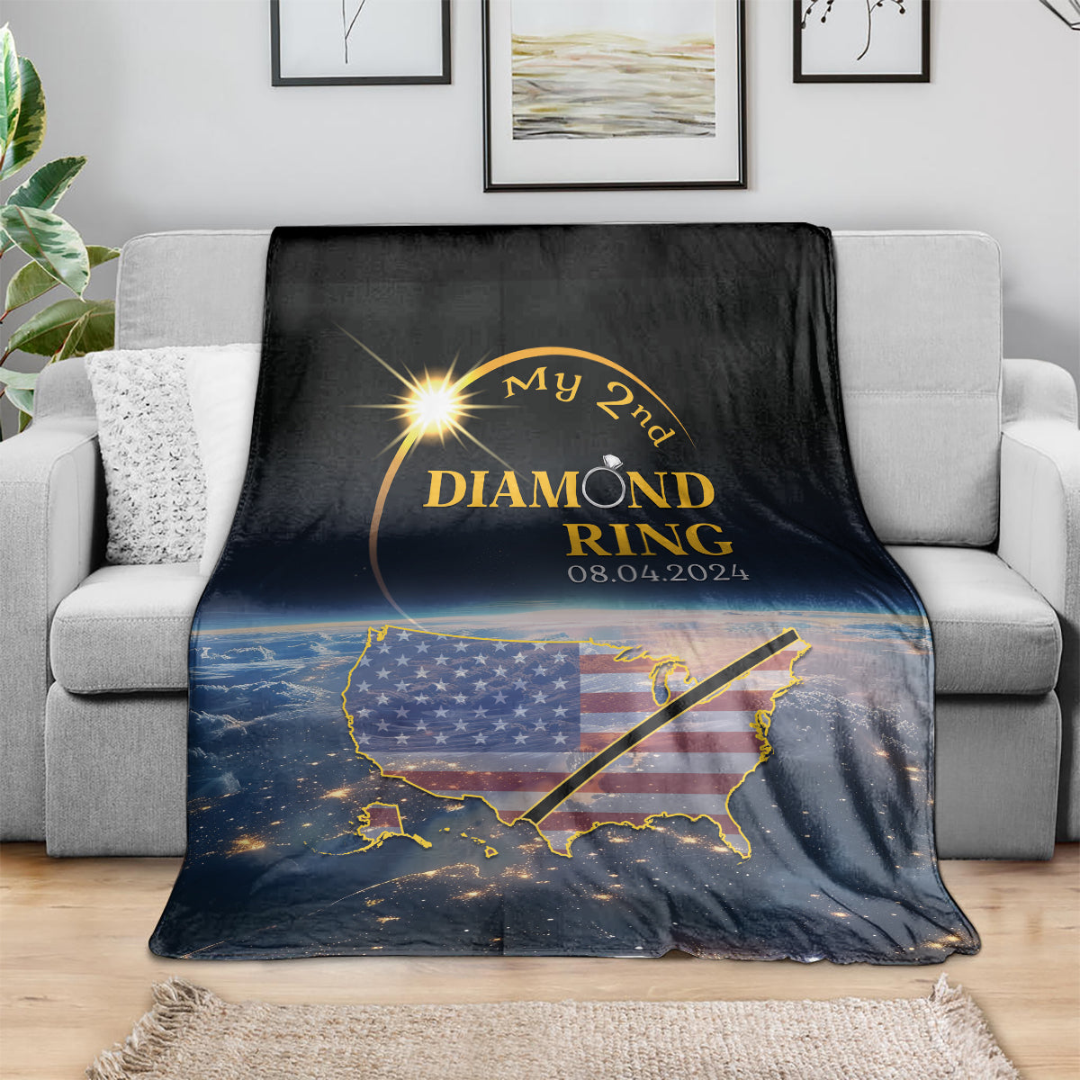 Black blanket on couch with diamond ring wording, US map graphic, and 08.04.2024