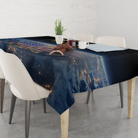 Black tablecloth with gold/orange cosmic print and draped corners over dining table