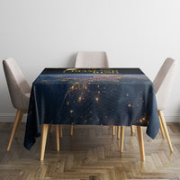 Black rectangular tablecloth with solar-eclipse style print in gold and orange
