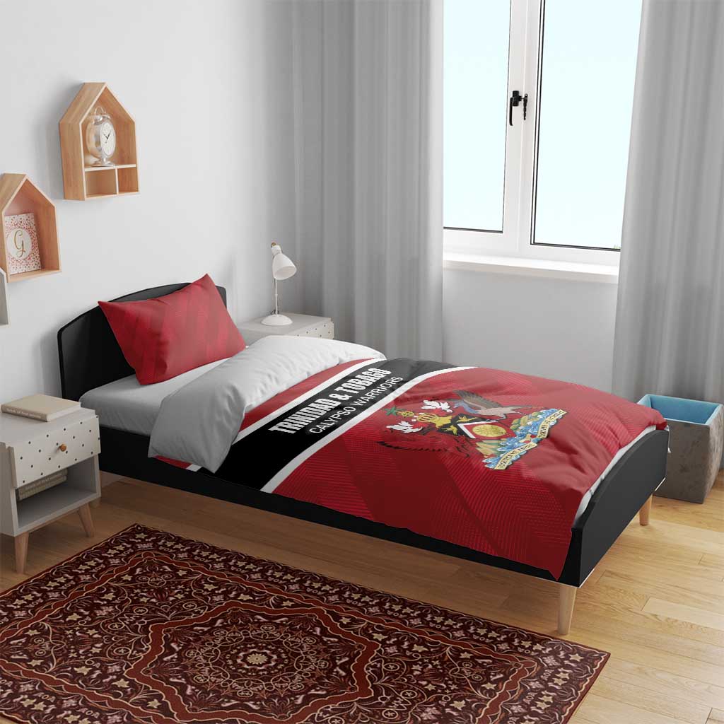 Red duvet cover and pillow shams with black/white stripe and crest graphic on bed