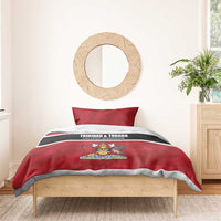 Red duvet cover with crest graphic and black/white stripe, displayed on bed