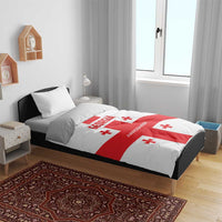 Georgia football bedding set on gray bed frame: white duvet with red cross and lettering.