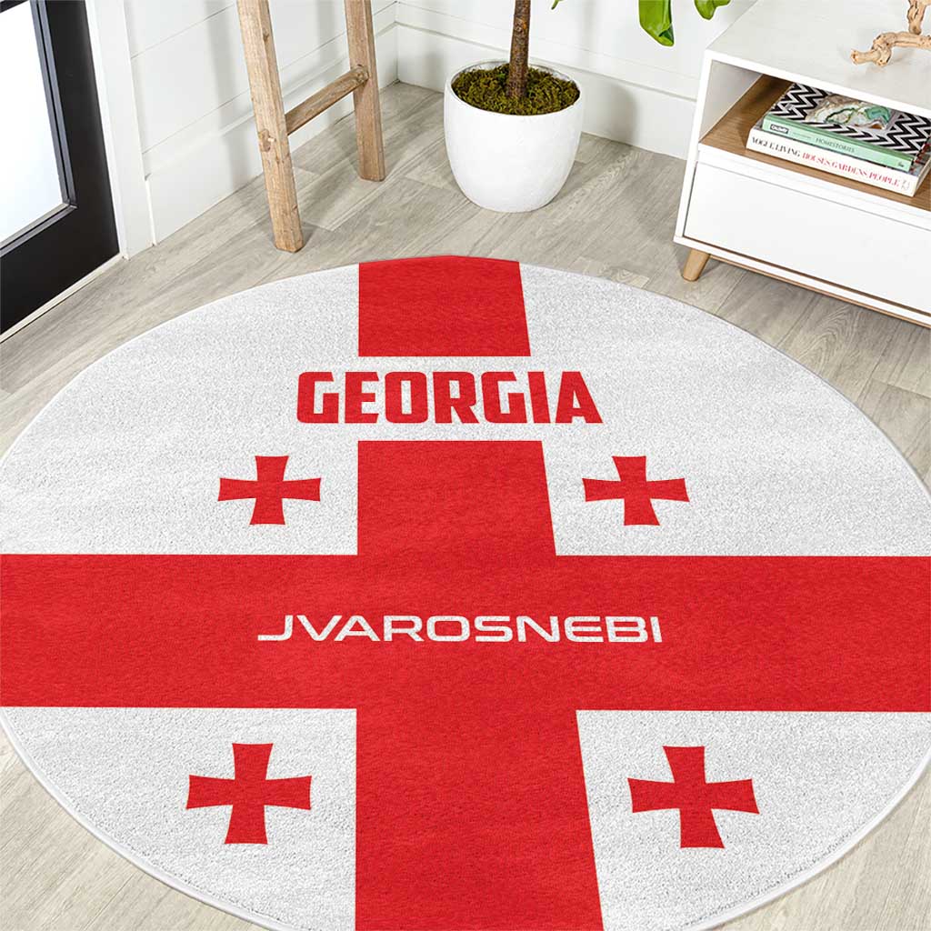 Red and white round carpet with central cross and Georgian text branding