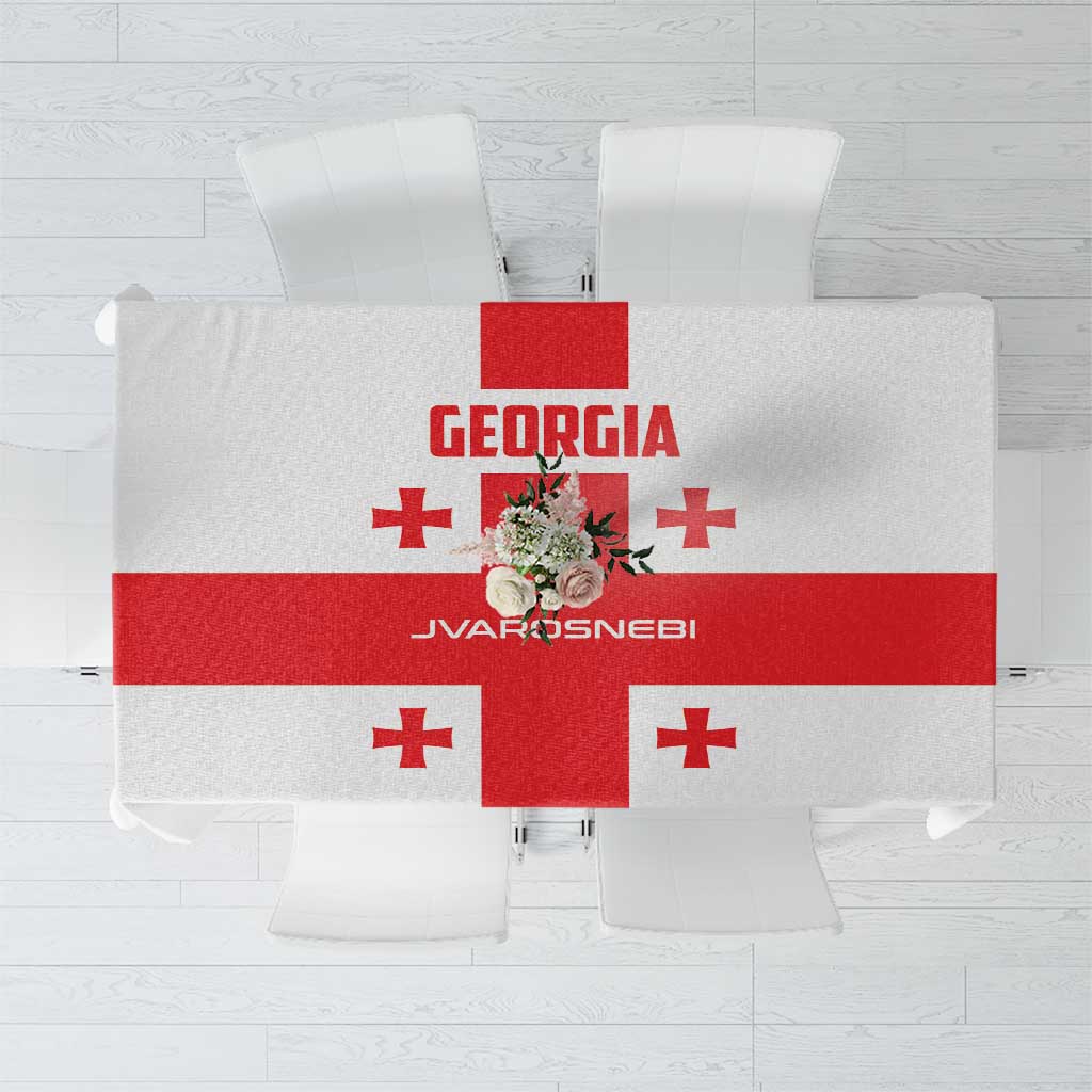 White tablecloth with Georgia emblem and red cross accents, laid flat.