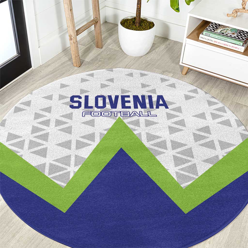 Round Slovenia football carpet close view: gray geometric field with green V chevron and blue edge