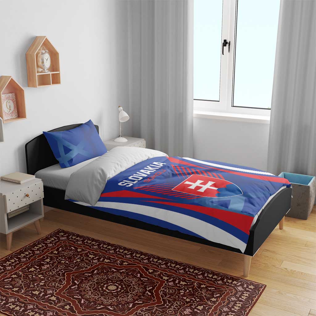 Blue bedding set on bed with Slovakia crest panel and red-striped border graphics