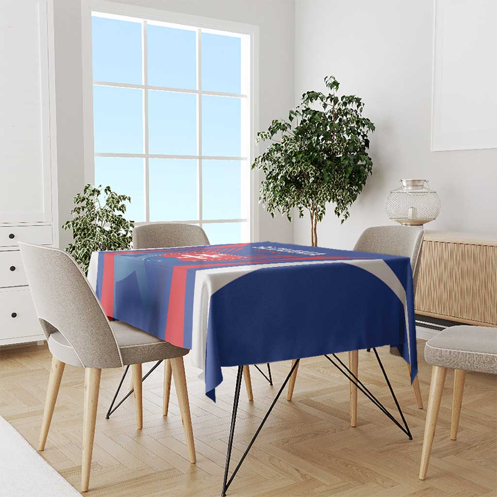Blue and red football tablecloth covering dining table with centered emblem graphic