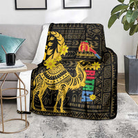 Black and gold camel blanket with Enkutatash logo, colorful vertical text blocks, flower accents
