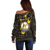 Off-shoulder black sweater with camel graphic and floral geometric pattern, back view.
