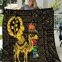 Black decorative quilt featuring a large yellow camel with colorful central details