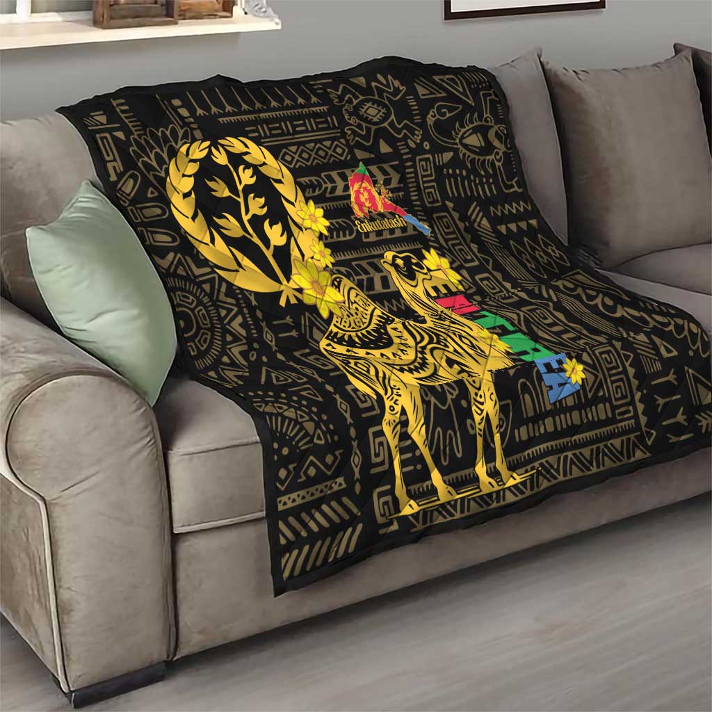 Black throw quilt on a sofa with yellow camel graphic and patterned geometric design