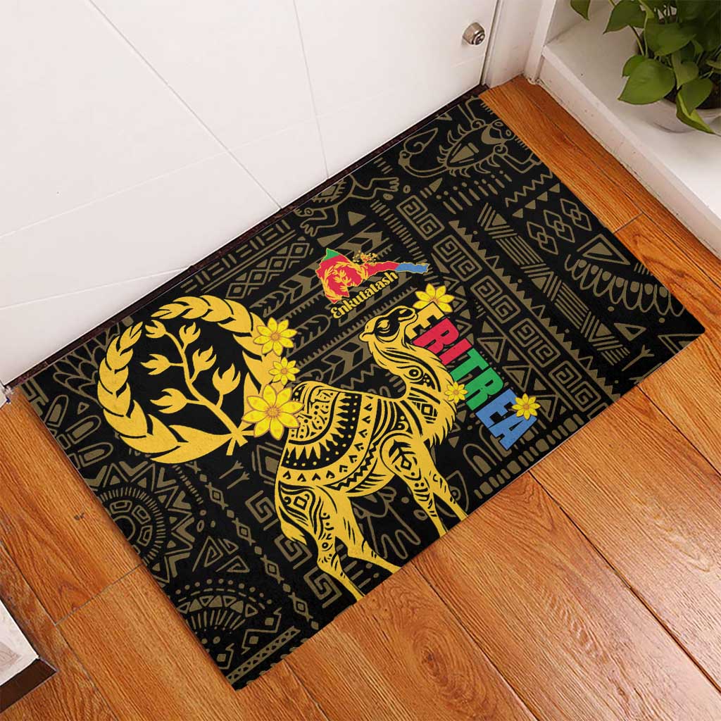 Black rubber doormat with gold camel graphic, geometric border, and red flower accents