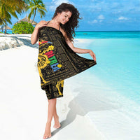 Black wrap sarong worn as a dress, gold camel and geometric print