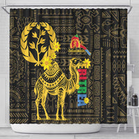 Black shower curtain with gold camel artwork, flower accents, and multicolor vertical text