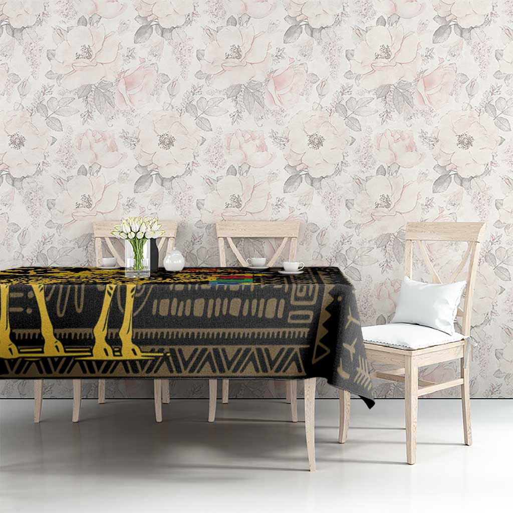 Black tablecloth with gold geometric design on long dining table