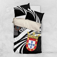 Black and white bedding set on bed: striped duvet with Ceuta crest and matching pillowcases