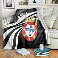 Black and white blanket with 'CEUTA' lettering and coat-of-arms crest over bedding