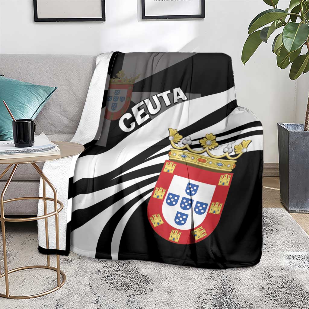 Black throw blanket with 'CEUTA' lettering and coat-of-arms crest over striped rays