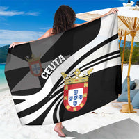 Black and white Ceuta sarong with bold stripes and crest emblem, draped over shoulders